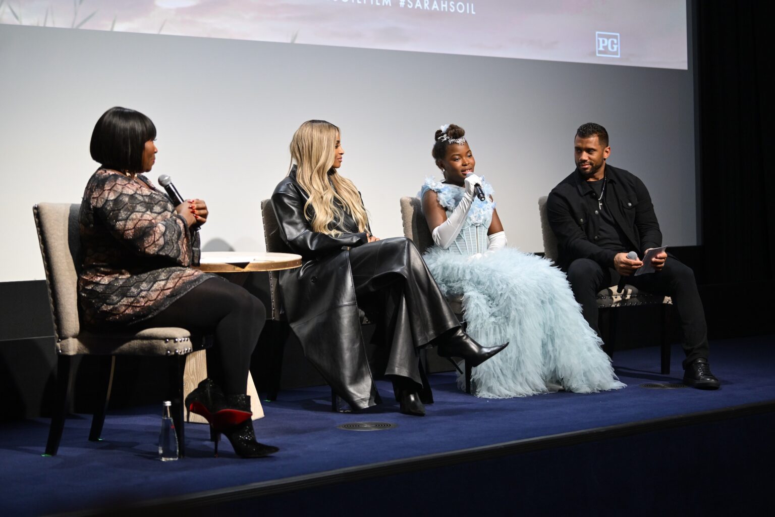NEW YORK, NEW YORK - NOVEMBER 05: (L-R) Bevy Smith, Ciara, Naya Desir-Johnson and Russell Wilson speak onstage during the NY special screening of Amazon MGM Studios "Sarah's Oil" at The Whitby Hotel on November 05, 2025 in New York City. (Photo by Valerie Terranova/Getty Images for Amazon MGM Studios)
