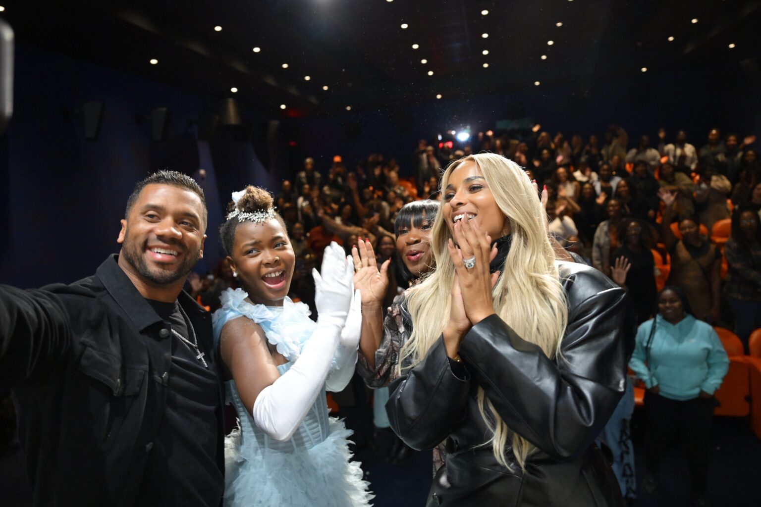 NEW YORK, NEW YORK - NOVEMBER 05: (L-R) Russell Wilson, Naya Desir-Johnson, Bevy Smith and Ciara take a selfie with the audience during NY special screening of Amazon MGM Studios "Sarah's Oil" at The Whitby Hotel on November 05, 2025 in New York City. (Photo by Valerie Terranova/Getty Images for Amazon MGM Studios)