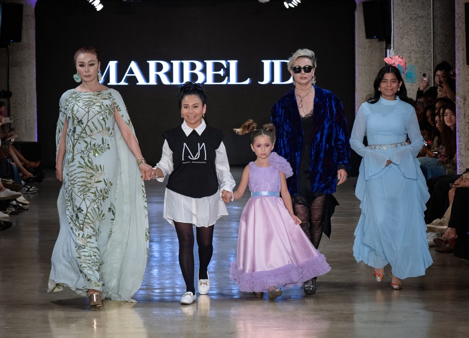 LOS ANGELES, CALIFORNIA - OCTOBER 18: Designer Maribel Julcahuanca and models walk the runway at the Maribel JD show during Los Angeles Fashion Week Powered By Art Hearts Fashion at The New Mart on October 18, 2025 in Los Angeles, California. (Photo by Mark Gunter/Getty Images for Art Hearts Fashion)