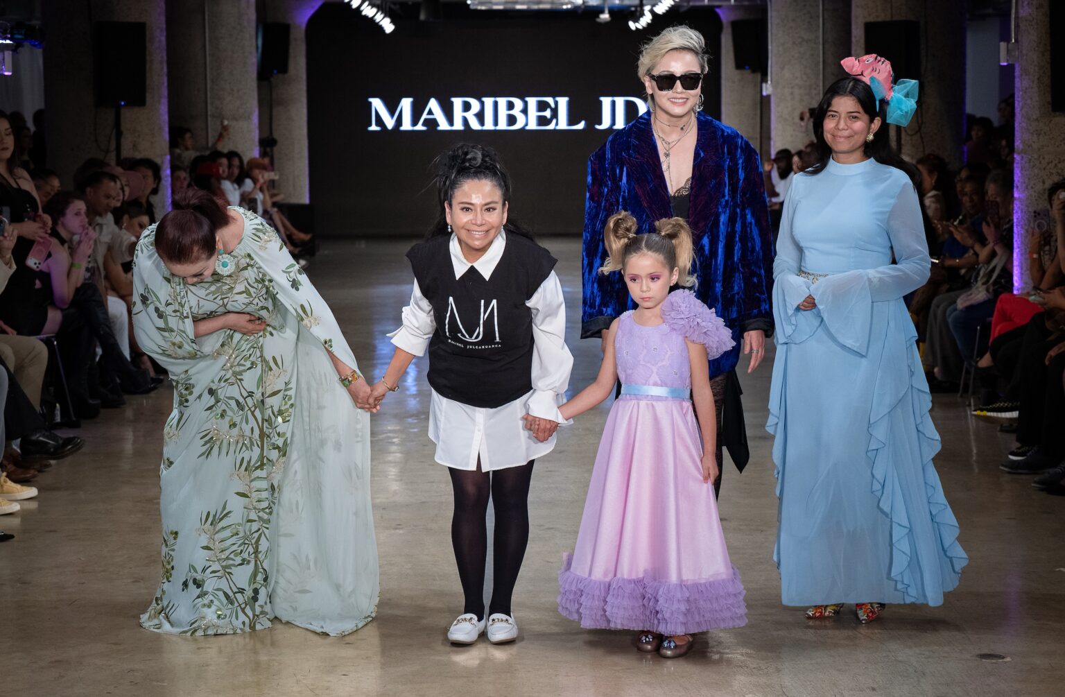 LOS ANGELES, CALIFORNIA - OCTOBER 18: Designer Maribel Julcahuanca and models walk the runway at the Maribel JD show during Los Angeles Fashion Week Powered By Art Hearts Fashion at The New Mart on October 18, 2025 in Los Angeles, California. (Photo by Mark Gunter/Getty Images for Art Hearts Fashion)