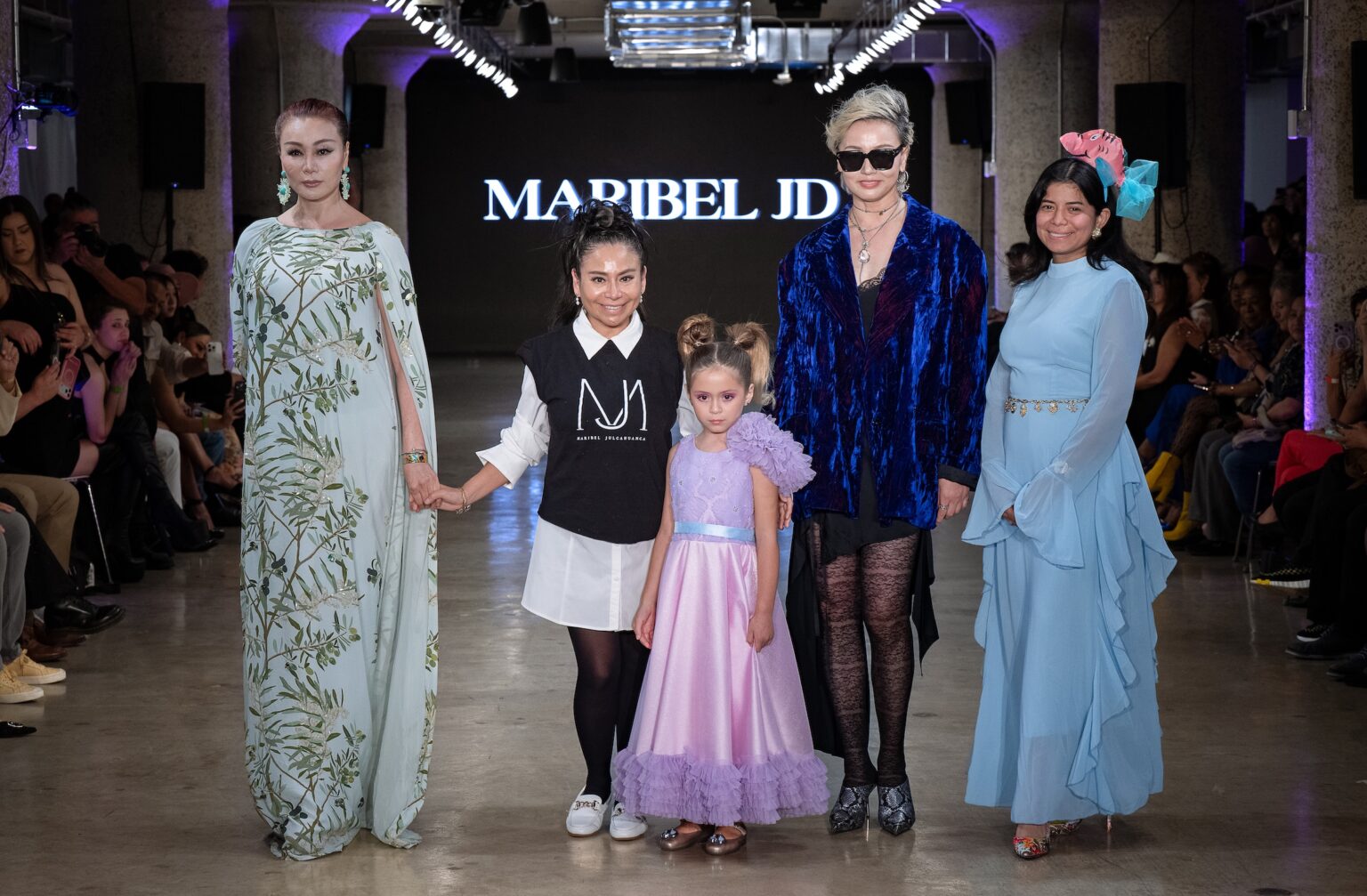 LOS ANGELES, CALIFORNIA - OCTOBER 18: Designer Maribel Julcahuanca and models walk the runway at the Maribel JD show during Los Angeles Fashion Week Powered By Art Hearts Fashion at The New Mart on October 18, 2025 in Los Angeles, California. (Photo by Mark Gunter/Getty Images for Art Hearts Fashion)