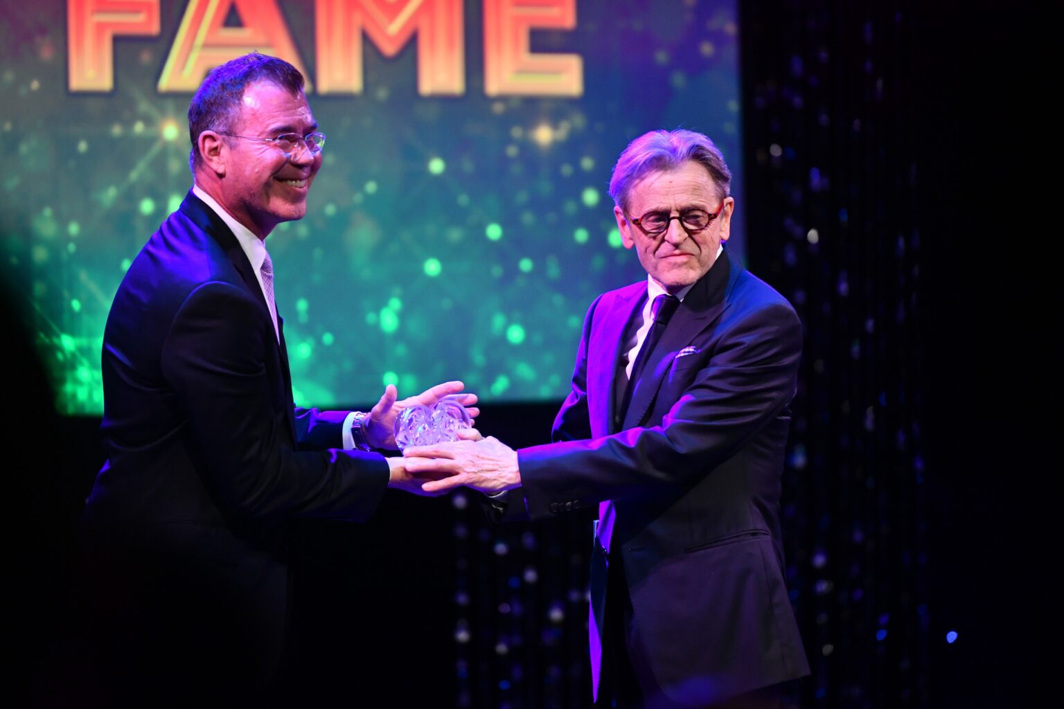 CULVER CITY, CALIFORNIA - DECEMBER 03: Jamie Bishton (L) inducts Mikhail Baryshnikov (R) into the Dance Hall of Fame onstage during the inaugural Dance Hall of Fame ceremony honoring the most influential artists in dance history at Glorya Kaufman Community Center on December 03, 2025 in Culver City, California. (Photo by Alberto E. Rodriguez/Getty Images for Dance Hall of Fame)