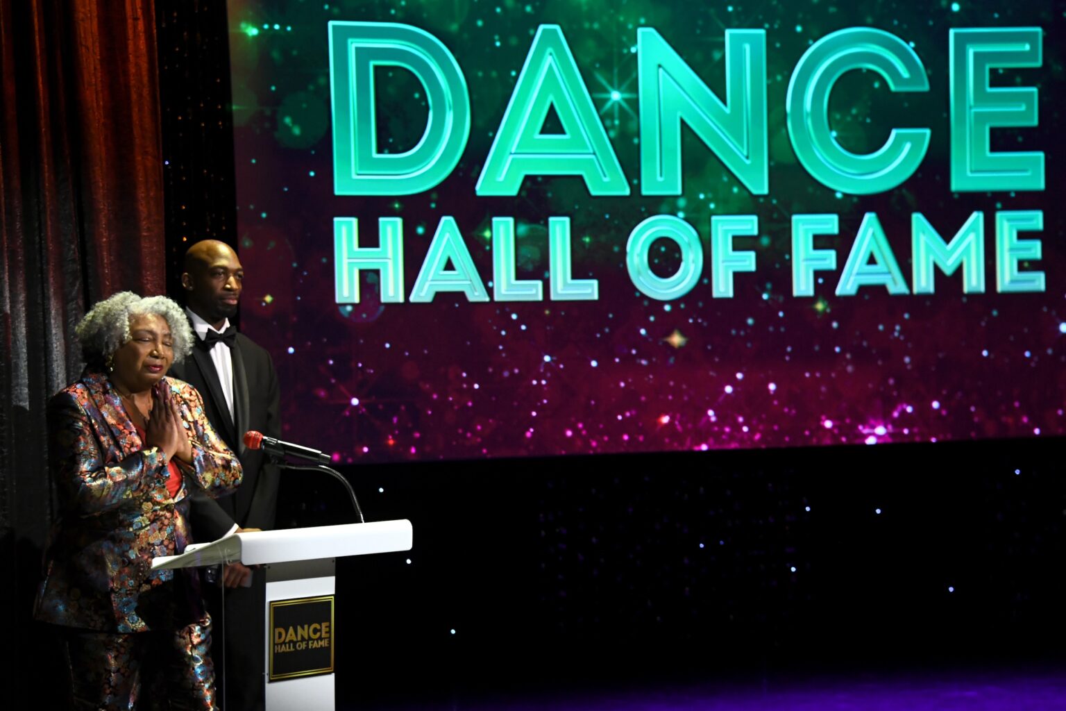 CULVER CITY, CALIFORNIA - DECEMBER 03: (L-R) Connie Boss Alexander and Drè Rose speak onstage during the inaugural Dance Hall of Fame ceremony honoring the most influential artists in dance history at Glorya Kaufman Community Center on December 03, 2025 in Culver City, California. (Photo by Alberto E. Rodriguez/Getty Images for Dance Hall of Fame)
