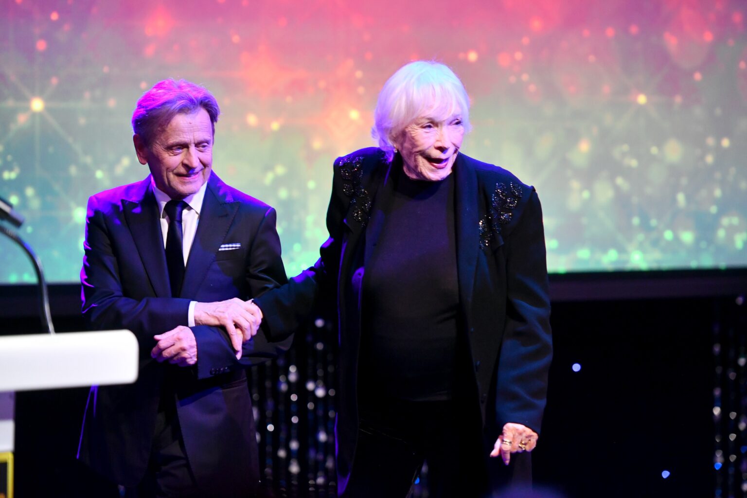 CULVER CITY, CALIFORNIA - DECEMBER 03: (L-R) Mikhail Baryshnikov and Shirley MacLaine are seen onstage during the inaugural Dance Hall of Fame ceremony honoring the most influential artists in dance history at Glorya Kaufman Community Center on December 03, 2025 in Culver City, California. (Photo by Alberto E. Rodriguez/Getty Images for Dance Hall of Fame)