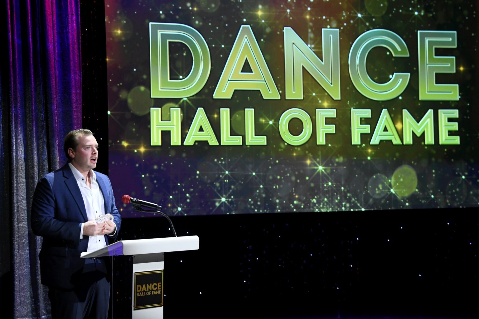 CULVER CITY, CALIFORNIA - DECEMBER 03: Noah Fosse accepts honor on behalf of Bob Fosse onstage during the inaugural Dance Hall of Fame ceremony honoring the most influential artists in dance history at Glorya Kaufman Community Center on December 03, 2025 in Culver City, California. (Photo by Alberto E. Rodriguez/Getty Images for Dance Hall of Fame)