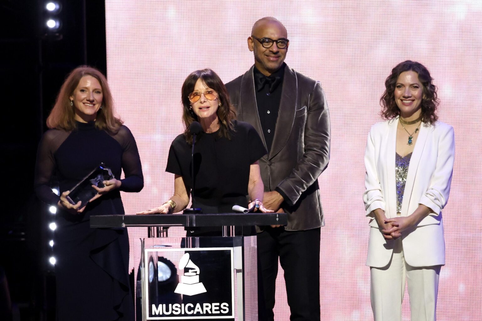 LOS ANGELES, CALIFORNIA - JANUARY 30: (L-R) Theresa Wolters, Executive Director, MusiCares, Jody Gerson, Harvey Mason jr., CEO, the Recording Academy, and Carianne Marshall speak onstage during 2026 MusiCares Person of the Year Honoring Mariah Carey on January 30, 2026 in Los Angeles, California. (Photo by Matt Winkelmeyer/Getty Images for The Recording Academy)