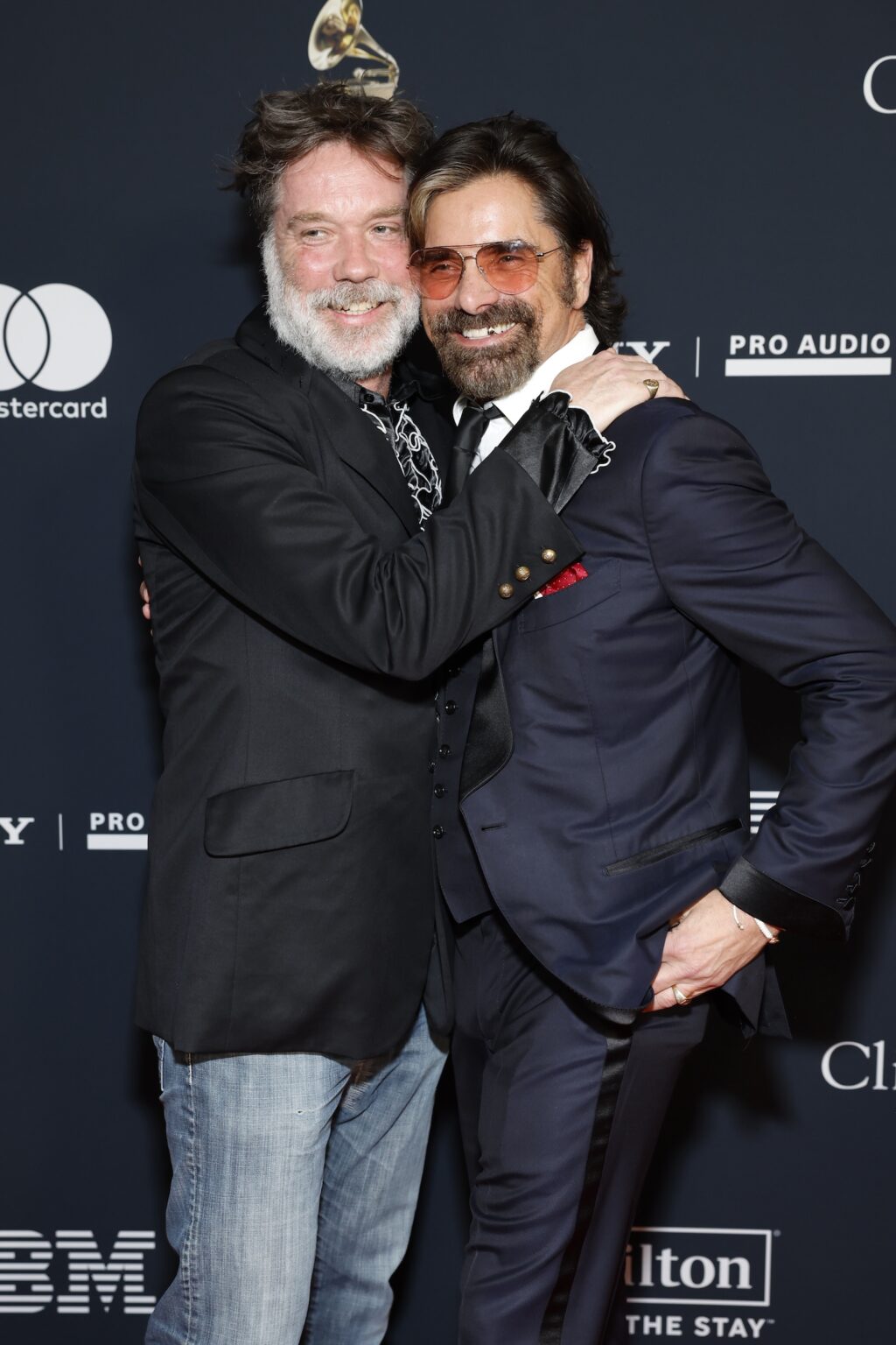 LOS ANGELES, CALIFORNIA - JANUARY 31: (L-R) Rufus Wainwright and John Stamos attend the 68th GRAMMY Awards Pre-GRAMMY Gala & GRAMMY Salute to Industry Icons Honoring Avery Lipman & Monte Lipman on January 31, 2026 in Los Angeles, California. (Photo by Leon Bennett/Getty Images for The Recording Academy)