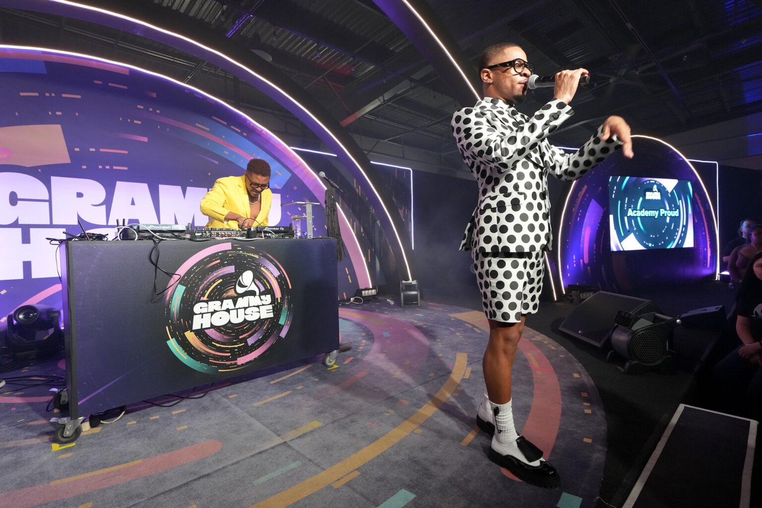 LOS ANGELES, CALIFORNIA - JANUARY 31: (R) Jus10 speaks onstage during the 68th GRAMMY Awards - GRAMMY House: Academy Proud on January 31, 2026 in Los Angeles, California. (Photo by Unique Nicole/Getty Images for The Recording Academy)