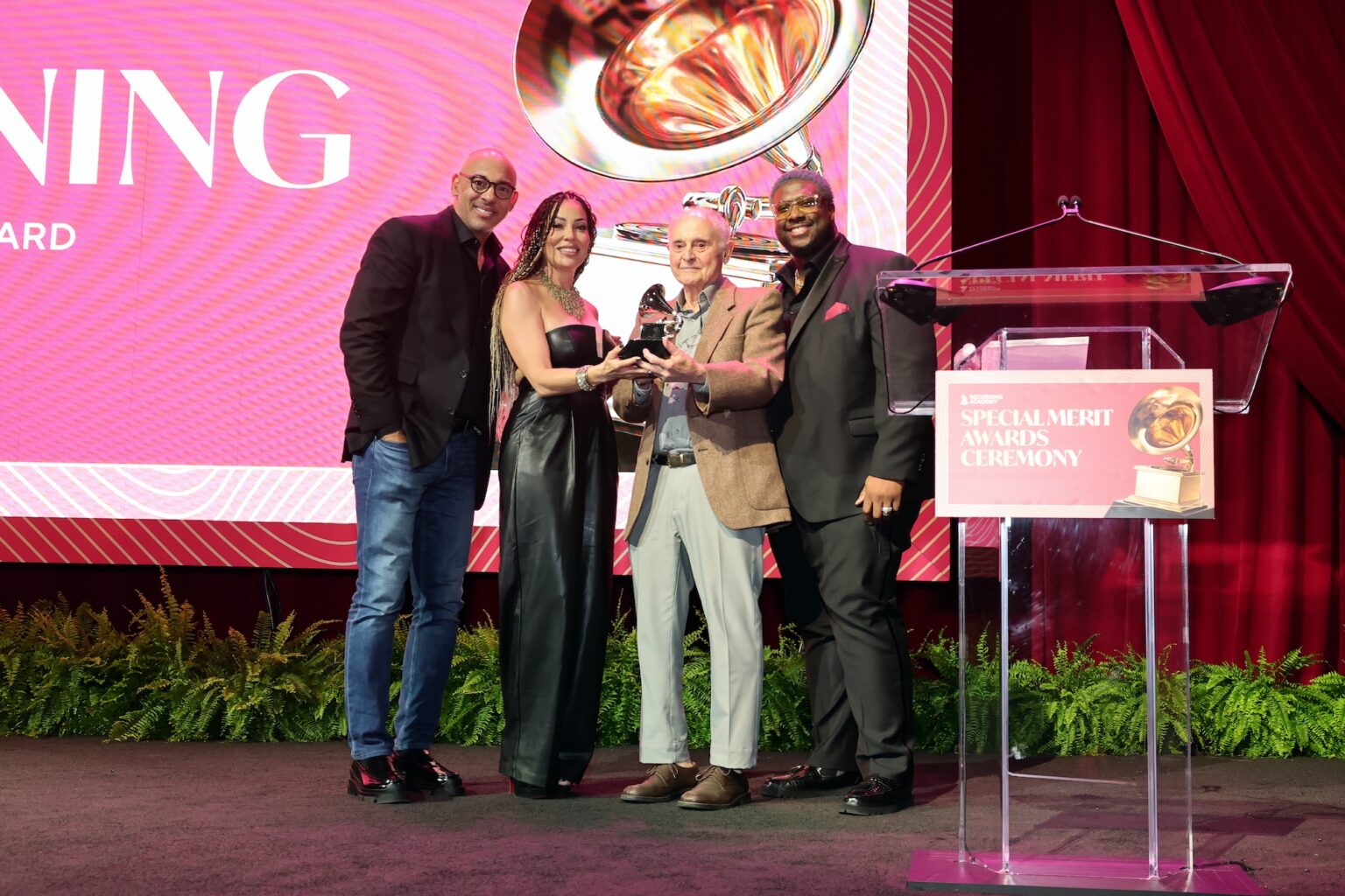 LOS ANGELES, CALIFORNIA - JANUARY 31: (L-R) Harvey Mason jr., CEO, the Recording Academy, Marcella Araica, John Chowning and Swagg R’Celious pose onstage during the Special Merit Awards Ceremony & 68th Annual GRAMMY Nominees Reception during the 68th GRAMMY Awards on January 31, 2026 in Los Angeles, California. (Photo by Emma McIntyre/Getty Images for The Recording Academy)