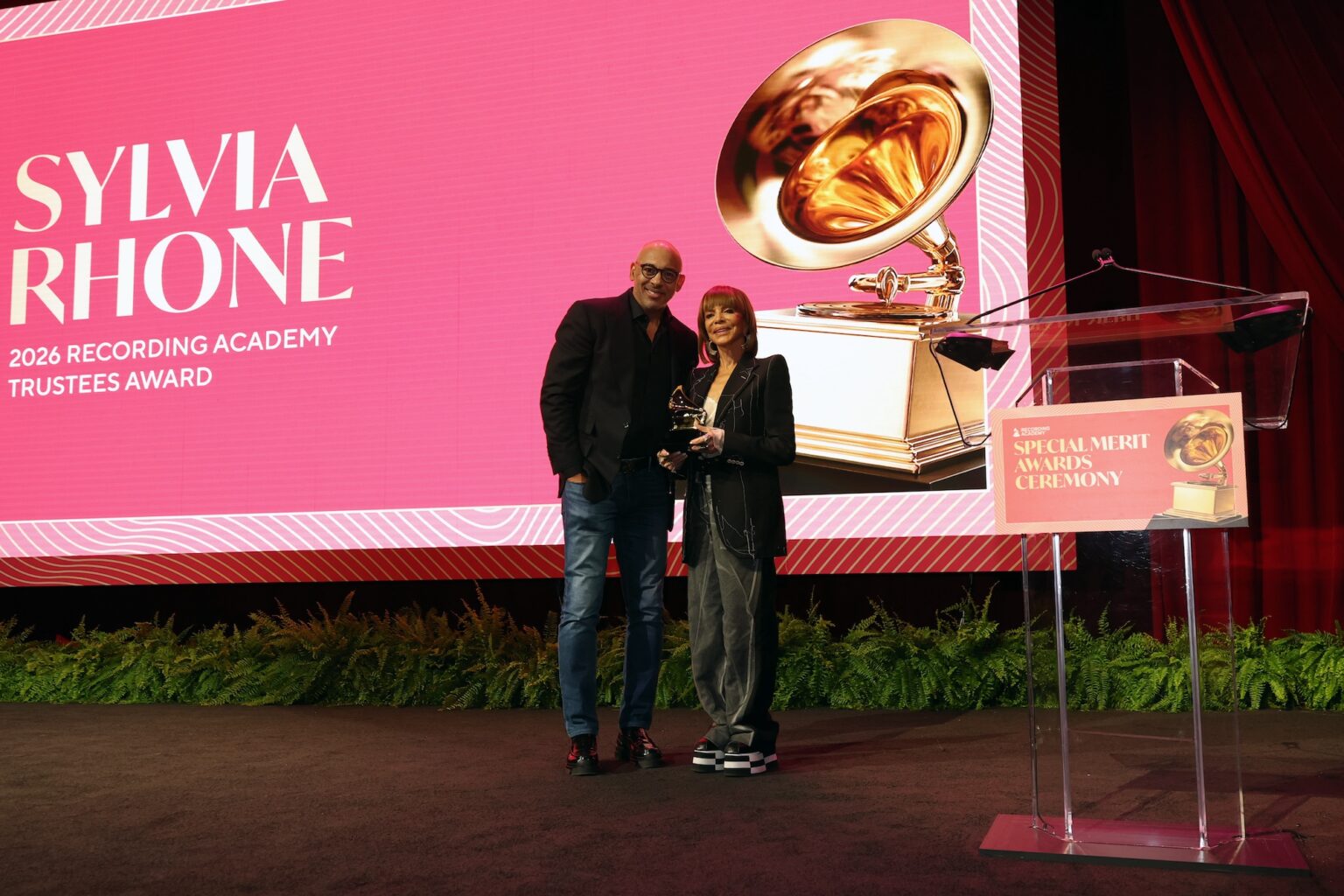 LOS ANGELES, CALIFORNIA - JANUARY 31: (L-R) Harvey Mason jr., CEO, the Recording Academy and Sylvia Rhone pose onstage during the Special Merit Awards Ceremony & 68th Annual GRAMMY Nominees Reception during the 68th GRAMMY Awards on January 31, 2026 in Los Angeles, California. (Photo by Mat Hayward/Getty Images for The Recording Academy)