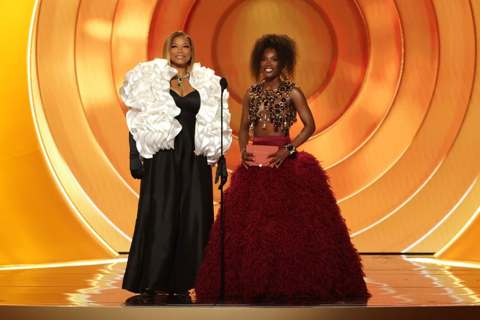 LOS ANGELES, CALIFORNIA - FEBRUARY 01: (L-R) Queen Latifah and Doechii speak onstage during the 68th GRAMMY Awards at Crypto.com Arena on February 01, 2026 in Los Angeles, California. (Photo by Kevin Winter/Getty Images for The Recording Academy)