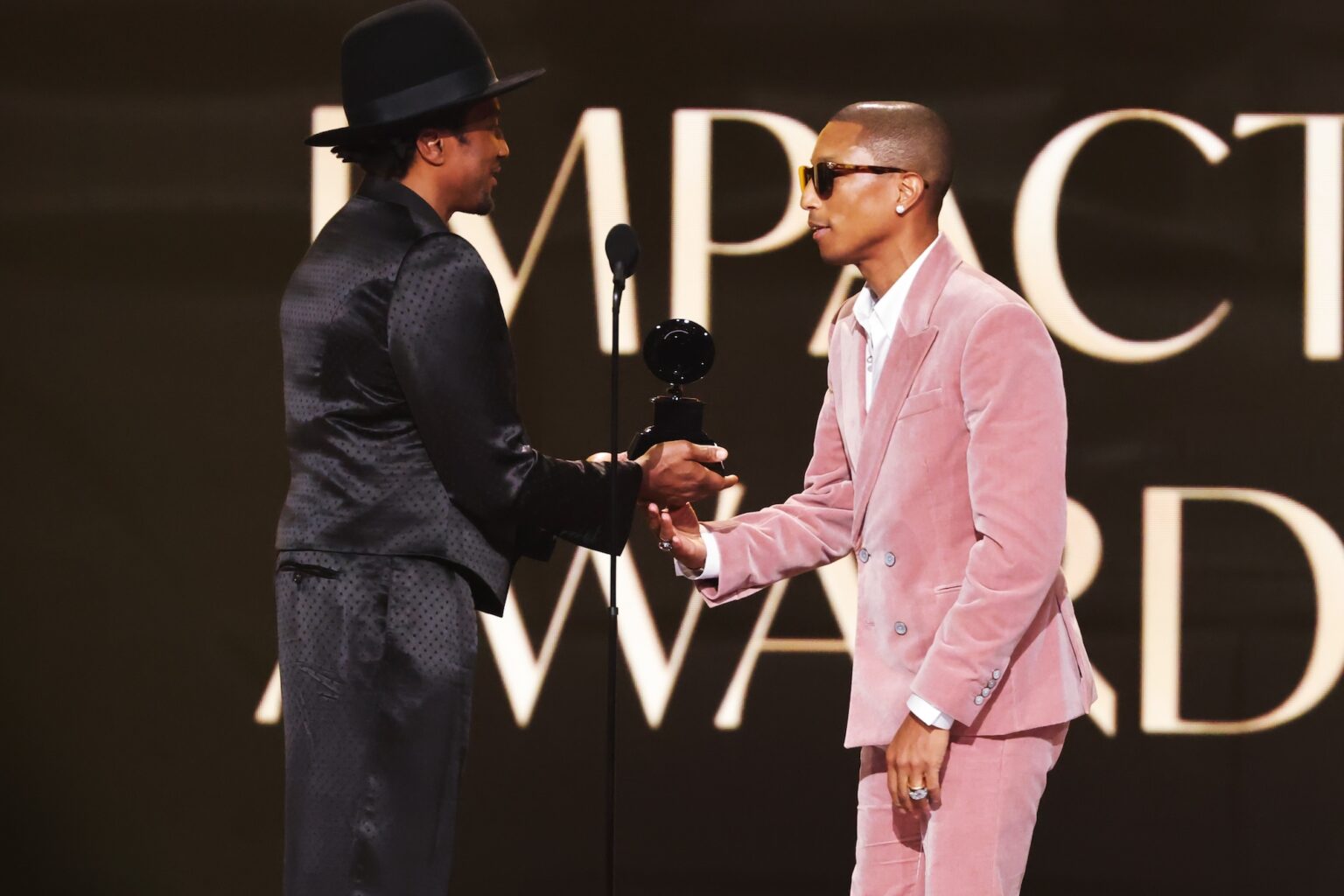 LOS ANGELES, CALIFORNIA - FEBRUARY 01: (L-R) Q-Tip presents the Dr. Dre Global Impact Award to honoree Pharrell Williams onstage during the 68th GRAMMY Awards at Crypto.com Arena on February 01, 2026 in Los Angeles, California. (Photo by Kevin Winter/Getty Images for The Recording Academy)