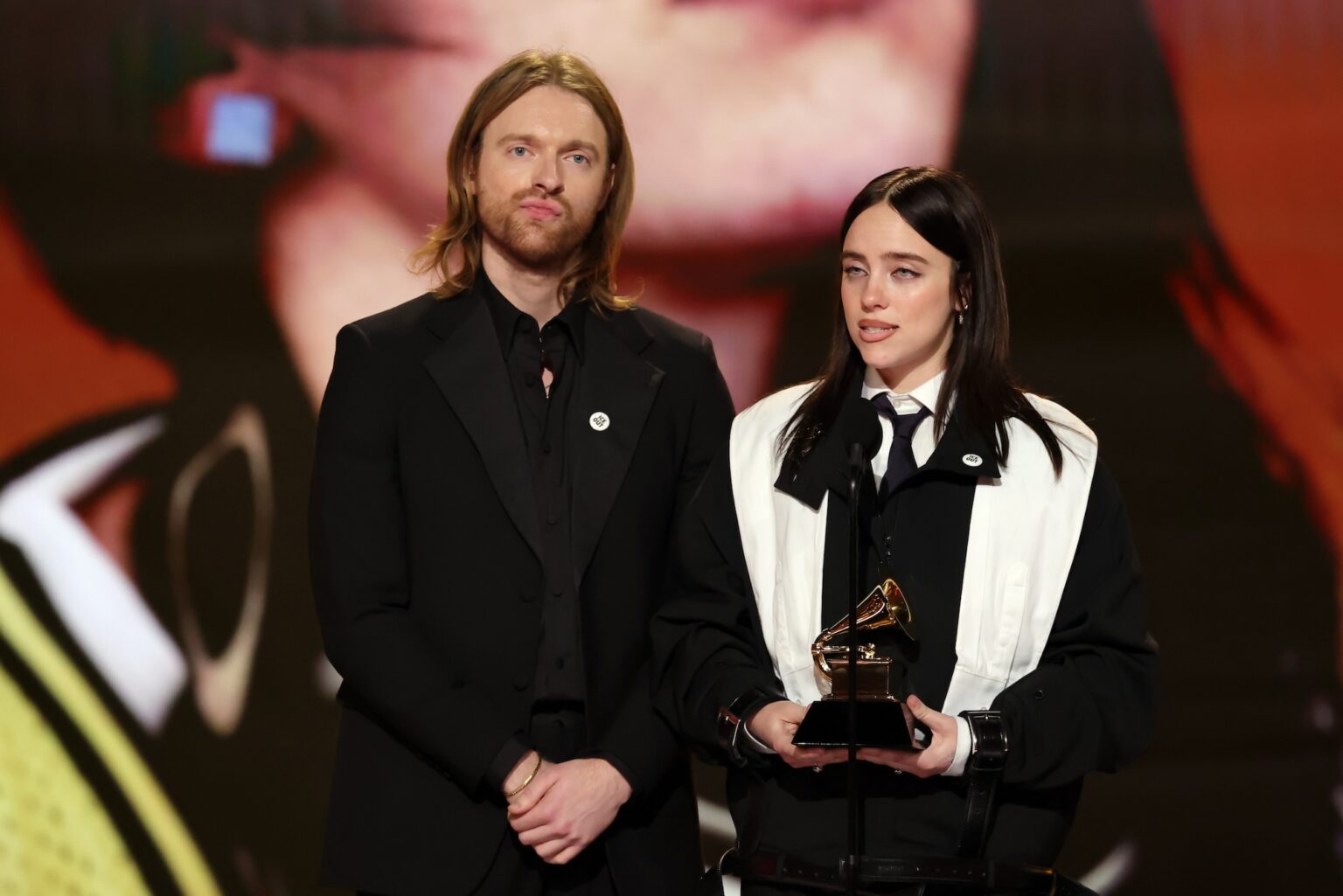 LOS ANGELES, CALIFORNIA - FEBRUARY 01: (L-R) Finneas O'Connell and Billie Eilish accept the Song Of The Year award for “WILDFLOWER” onstage during the 68th GRAMMY Awards at Crypto.com Arena on February 01, 2026 in Los Angeles, California. (Photo by Kevin Winter/Getty Images for The Recording Academy)