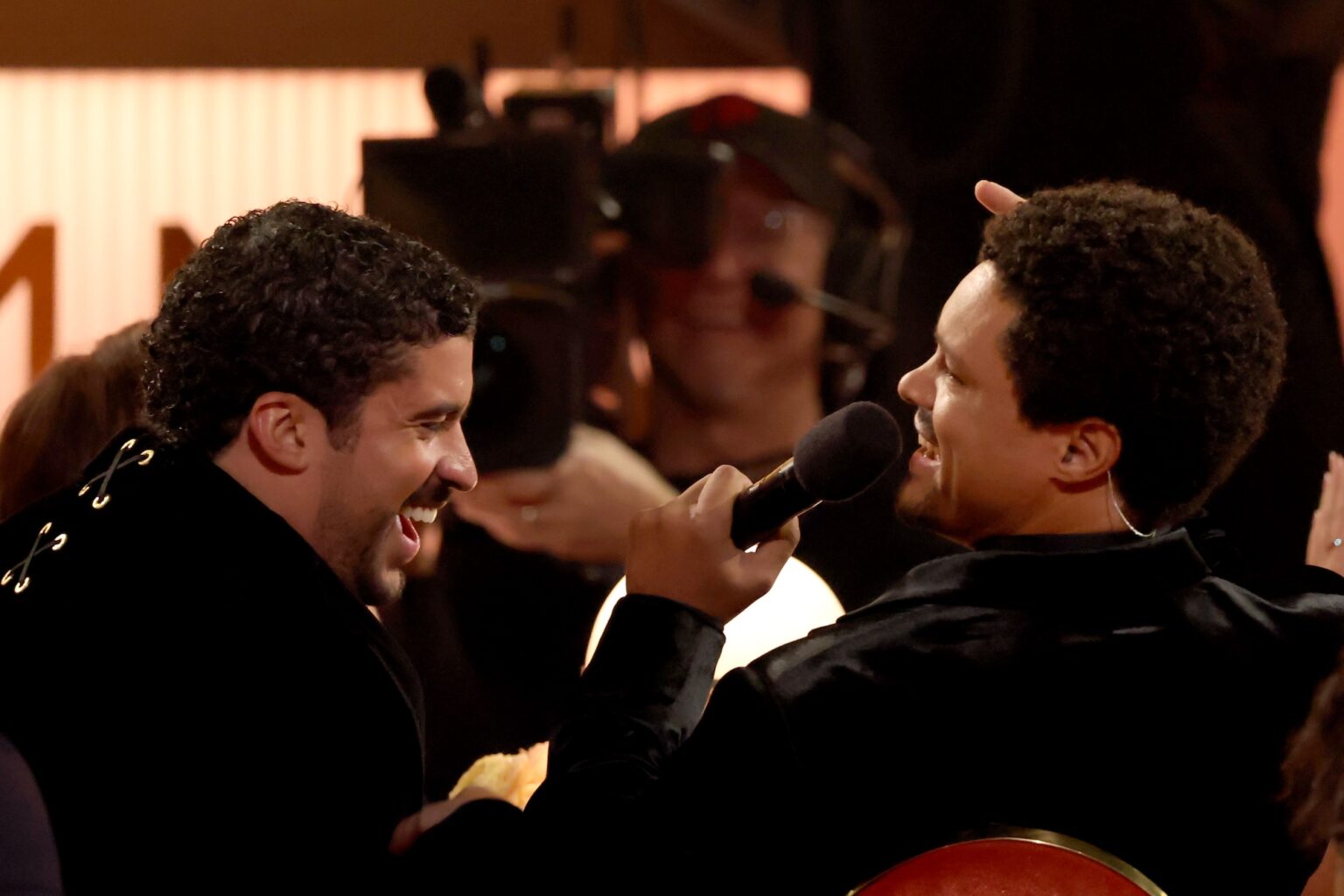 LOS ANGELES, CALIFORNIA - FEBRUARY 01: (L-R) Bad Bunny and Trevor Noah speak during the 68th GRAMMY Awards at Crypto.com Arena on February 01, 2026 in Los Angeles, California. (Photo by Kevin Winter/Getty Images for The Recording Academy)