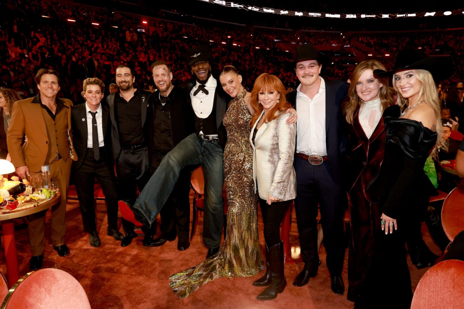 LOS ANGELES, CALIFORNIA - FEBRUARY 01: (L-R) Lukas Nelson, Brandi Carlile, Noah Kahan, Jelly Roll, Shaboozey, Kelsea Ballerini, Reba McEntire, Zach Top, Brandy Clark and Lainey Wilson attend the 68th GRAMMY Awards at Crypto.com Arena on February 01, 2026 in Los Angeles, California. (Photo by Kevin Mazur/Getty Images for The Recording Academy)
