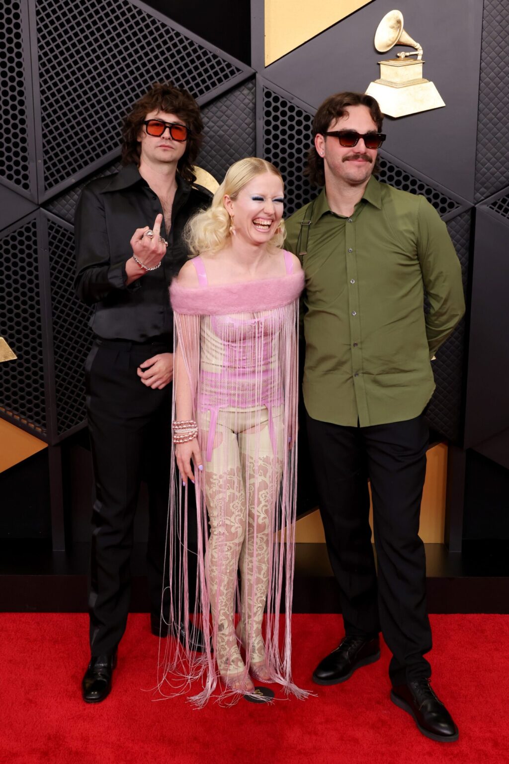 LOS ANGELES, CALIFORNIA - FEBRUARY 01: (L-R) Declan Mehrtens, Amy Taylor and Bryce Wilson of Amyl and the Sniffers attend the 68th GRAMMY Awards on February 01, 2026 in Los Angeles, California. (Photo by John Shearer/Getty Images for The Recording Academy)