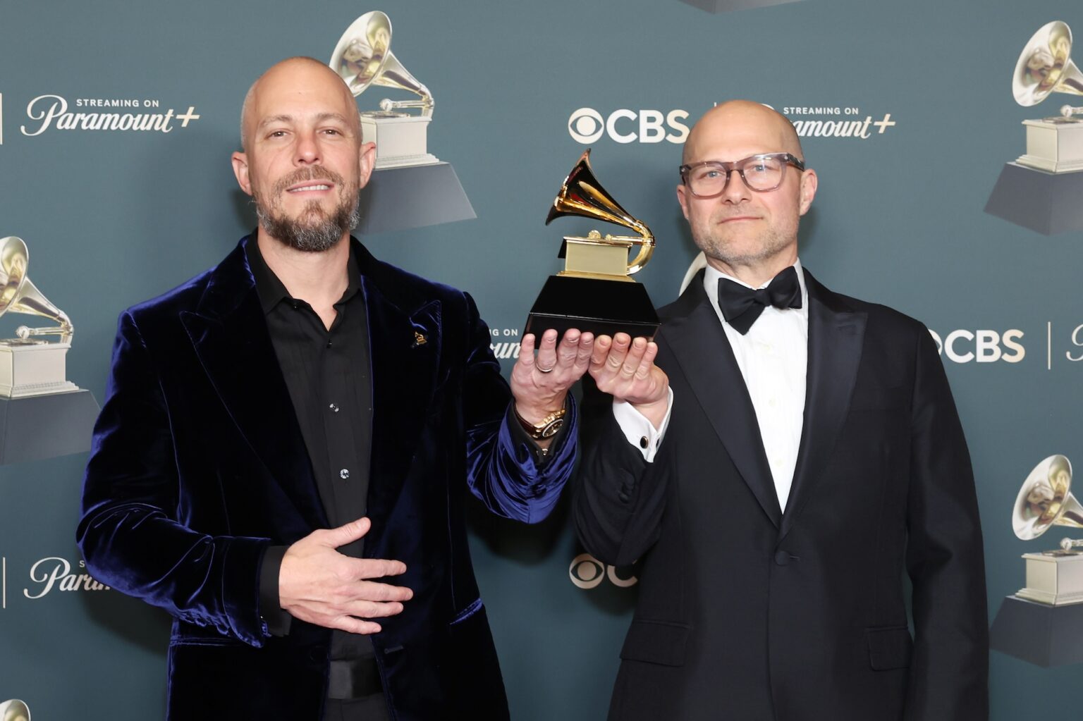 LOS ANGELES, CALIFORNIA - FEBRUARY 01: (L-R) Josh Gudwin and Colin Leonard, winners of Album of the Year for "DeBÕ TiRAR M·S FOToS,", pose in the press room during the 68th GRAMMY Awards at Crypto.com Arena on February 01, 2026 in Los Angeles, California. (Photo by Leon Bennett/Getty Images for The Recording Academy)