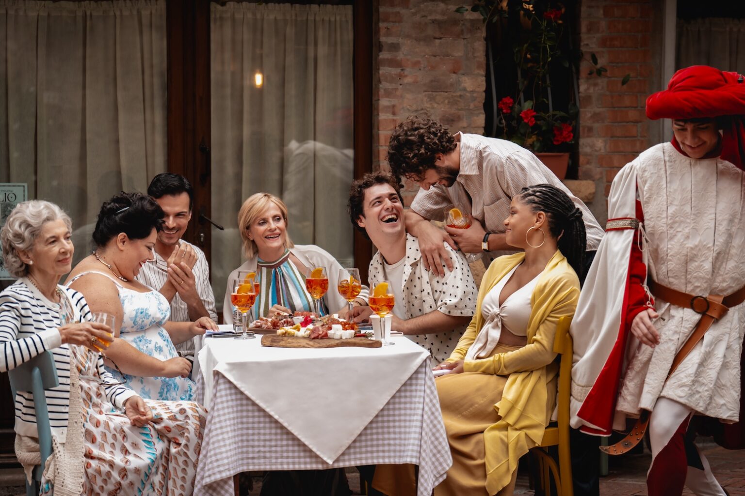 (from left) Nonna Alessia (Stefania Casini), Francesca (Stella Pecollo), Leo (Luca Setaccioli), Gabriella (Isabella Ferrari), Enzo (Tommaso Cassissa), Matteo (Lorenzo de Moor) and Anna (Halle Bailey) in You, Me & Tuscany, directed by Kat Coiro.