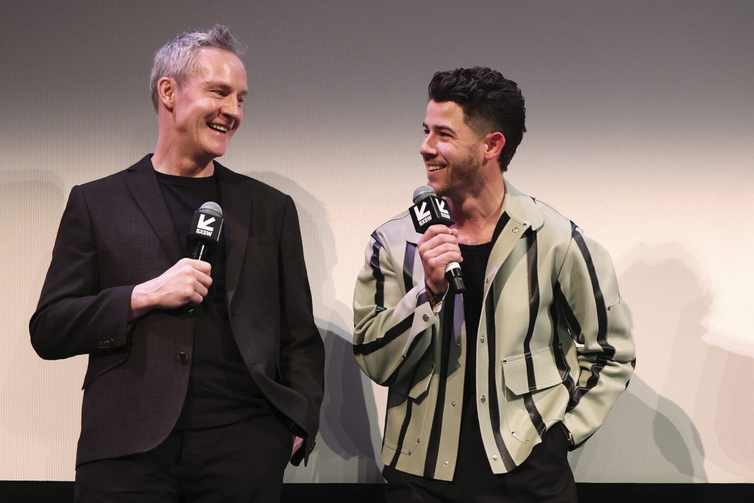 AUSTIN, TEXAS - MARCH 14: (L-R) Peter McDonald and Nick Jonas speak onstage during the premiere of "Power Ballad" during SXSW at The Paramount Theatre on March 14, 2026 in Austin, Texas. (Photo by Robin Marchant/Getty Images for Lionsgate)
