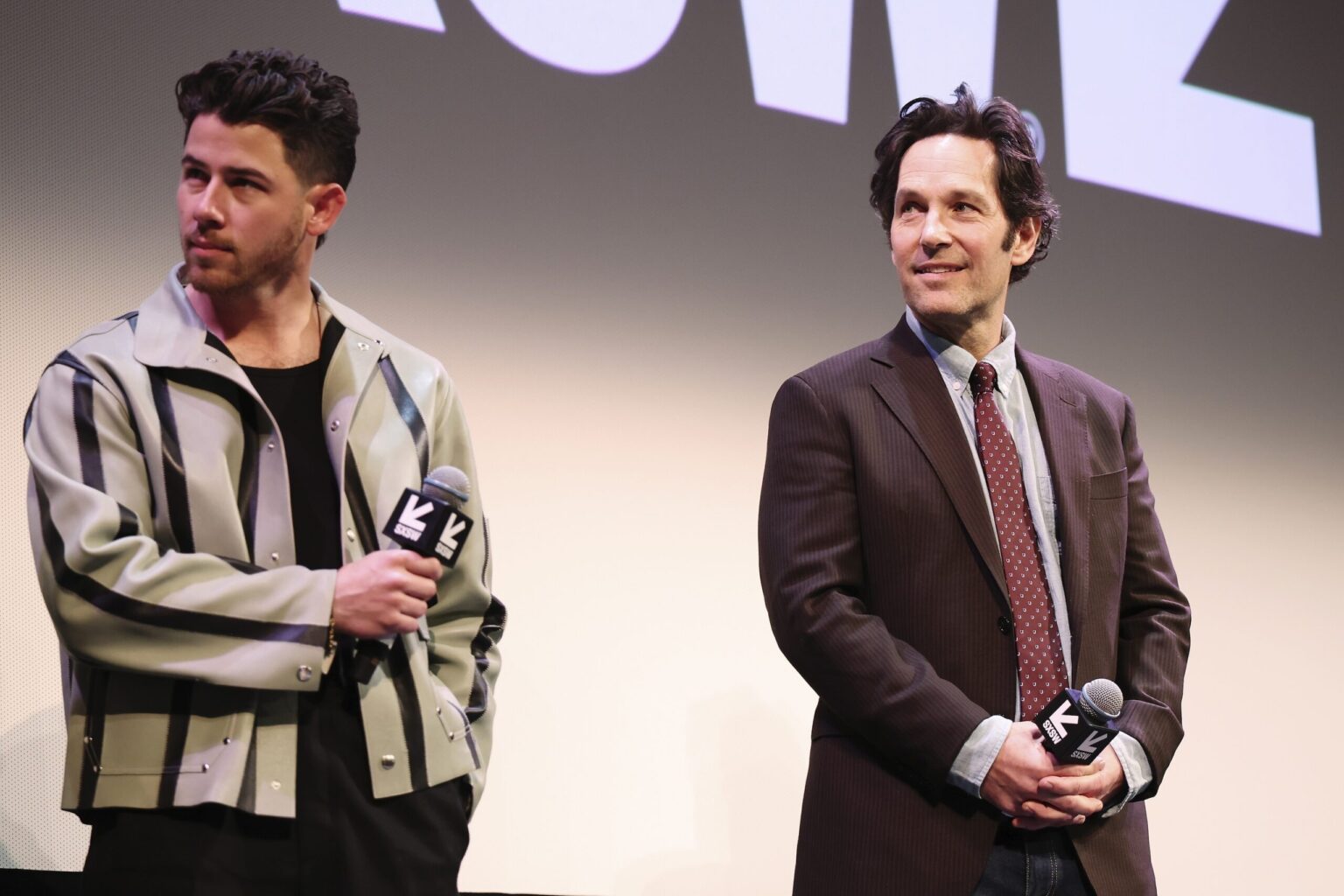 AUSTIN, TEXAS - MARCH 14: (L-R) Nick Jonas and Paul Rudd speak onstage during the premiere of "Power Ballad" during SXSW at The Paramount Theatre on March 14, 2026 in Austin, Texas. (Photo by Robin Marchant/Getty Images for Lionsgate)