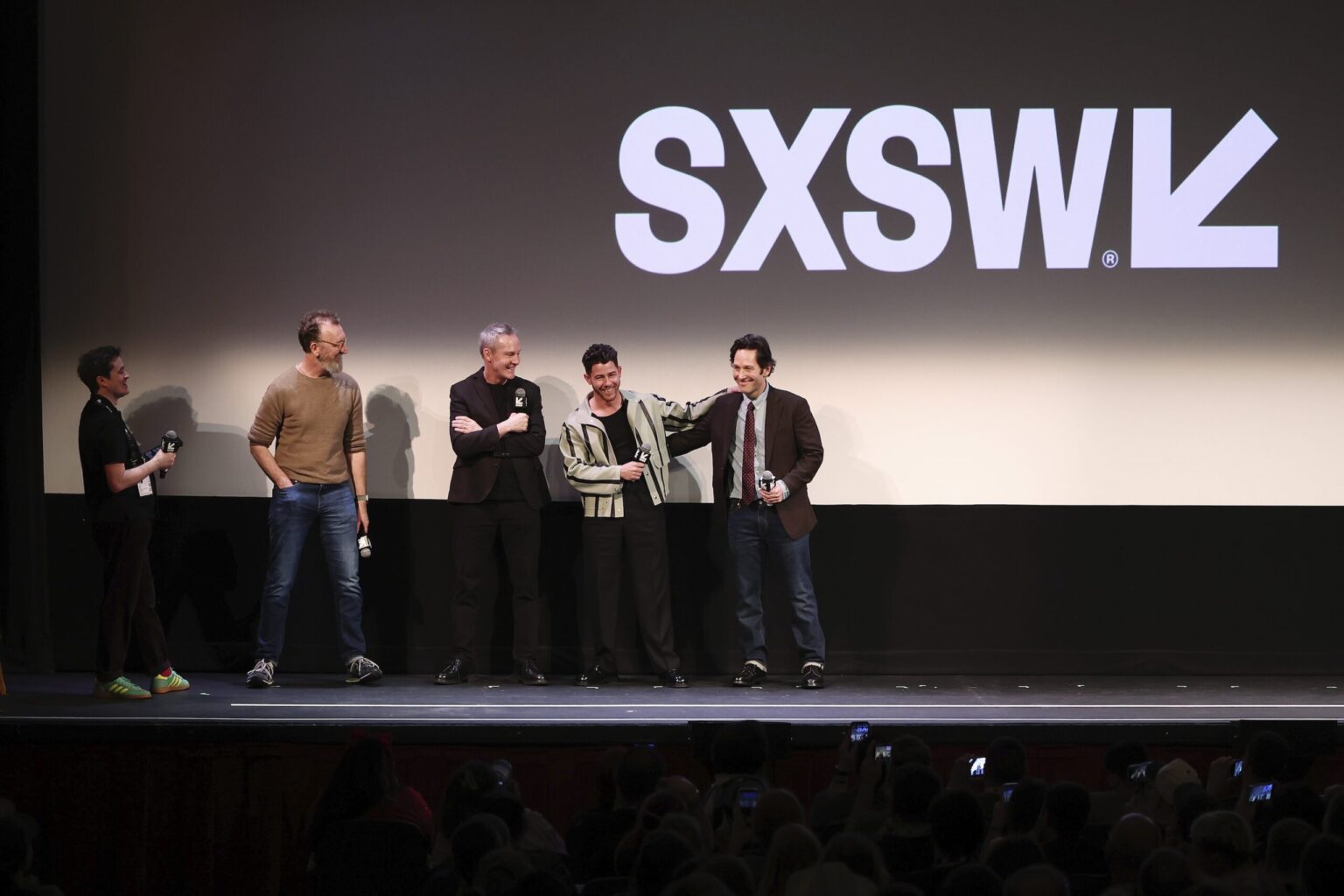 AUSTIN, TEXAS - MARCH 14: (L-R) Jim Kolmar, John Carney, Peter McDonald, Nick Jonas and Paul Rudd speak onstage during the premiere of "Power Ballad" during SXSW at The Paramount Theatre on March 14, 2026 in Austin, Texas. (Photo by Robin Marchant/Getty Images for Lionsgate)