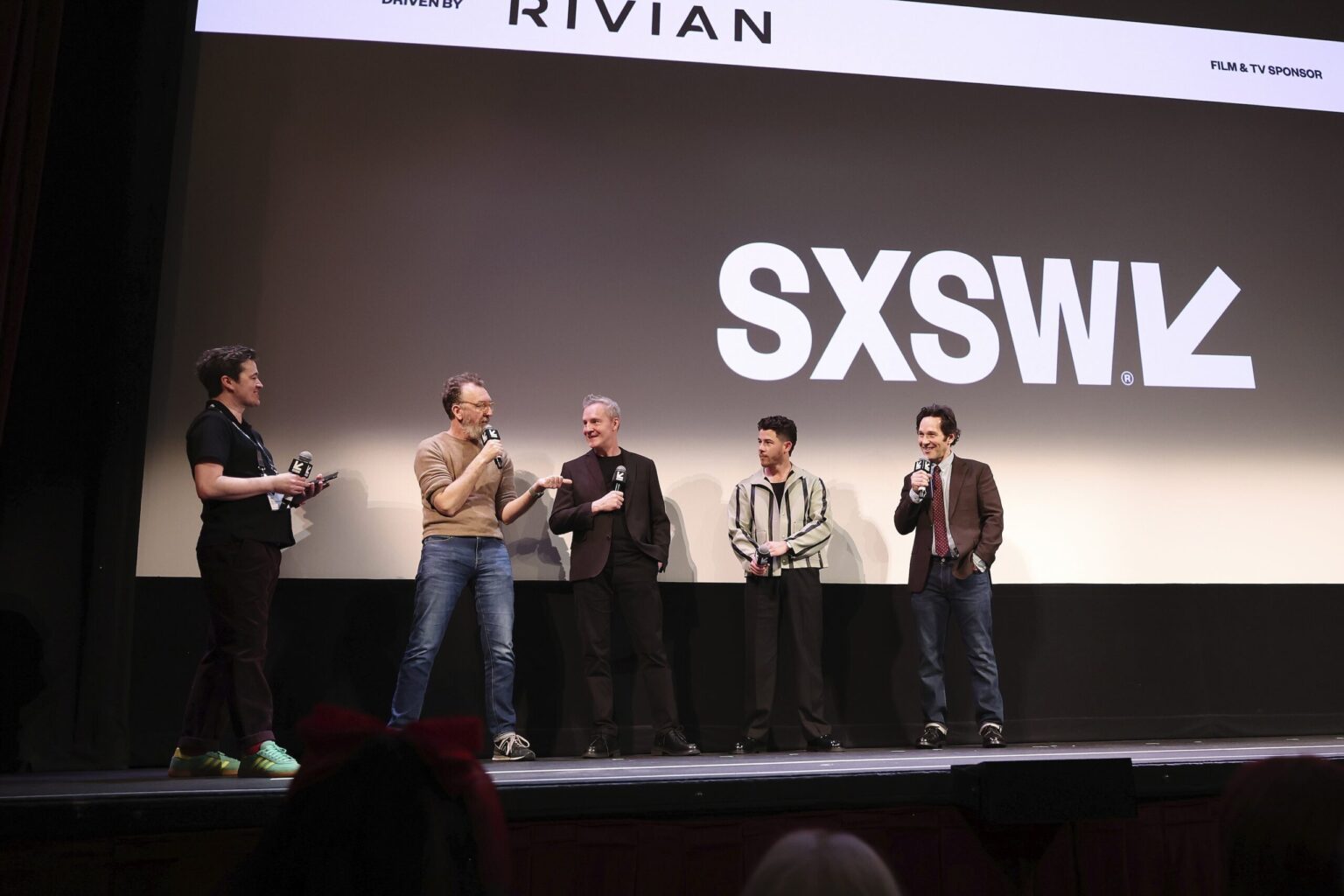 AUSTIN, TEXAS - MARCH 14: (L-R) Jim Kolmar, John Carney, Peter McDonald, Nick Jonas and Paul Rudd speak onstage during the premiere of "Power Ballad" during SXSW at The Paramount Theatre on March 14, 2026 in Austin, Texas. (Photo by Robin Marchant/Getty Images for Lionsgate)