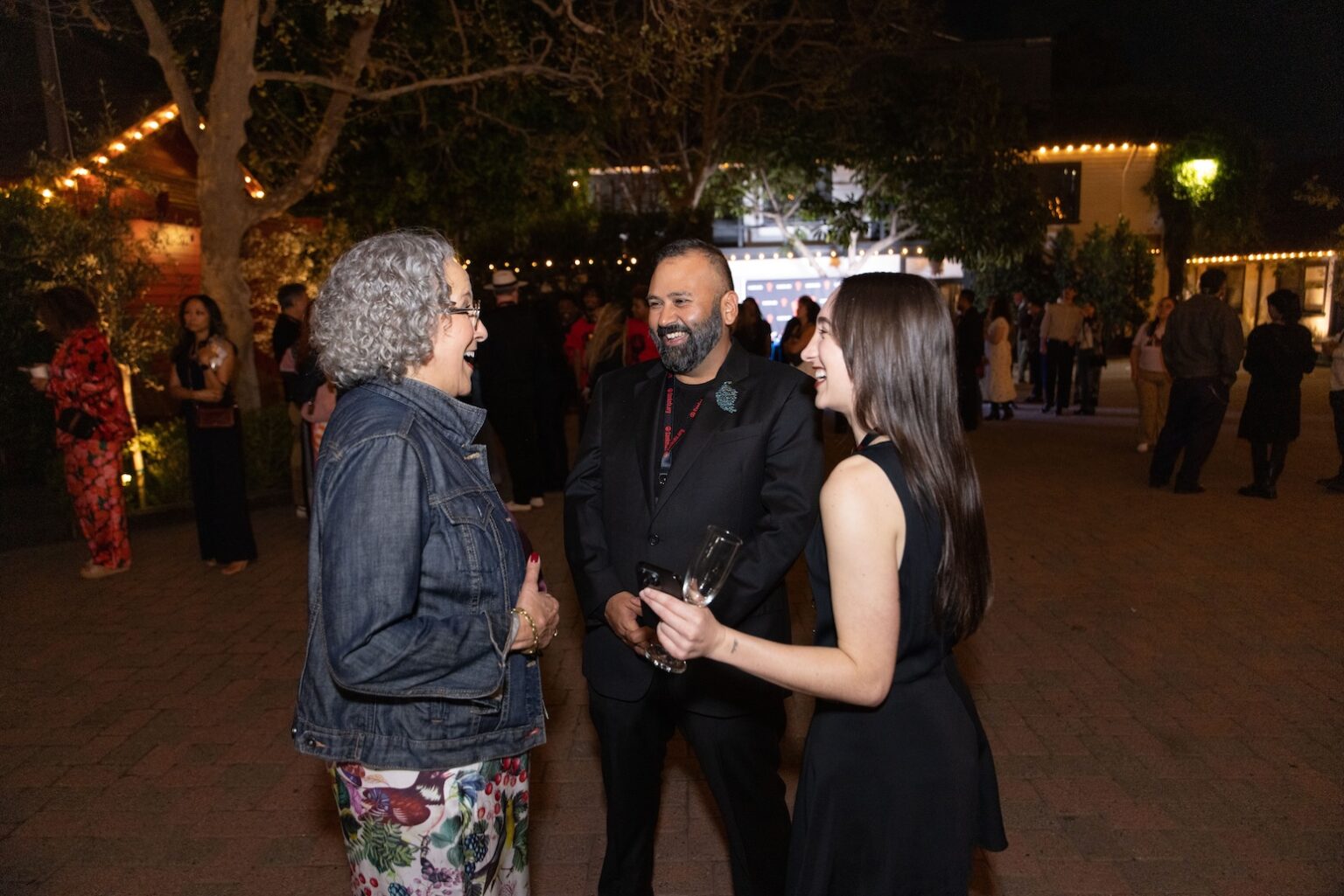 LOS ANGELES, CALIFORNIA - MARCH 1: Gina Belafonte laughs with Maria Belafonte and Ameet Shukla with guests during the inaugural Sankofa.org Social Justice Awards at Chaplin Studios on March 1, 2026 in Los Angeles, California. (Photo by Todd Westphal / Sankofa.org)