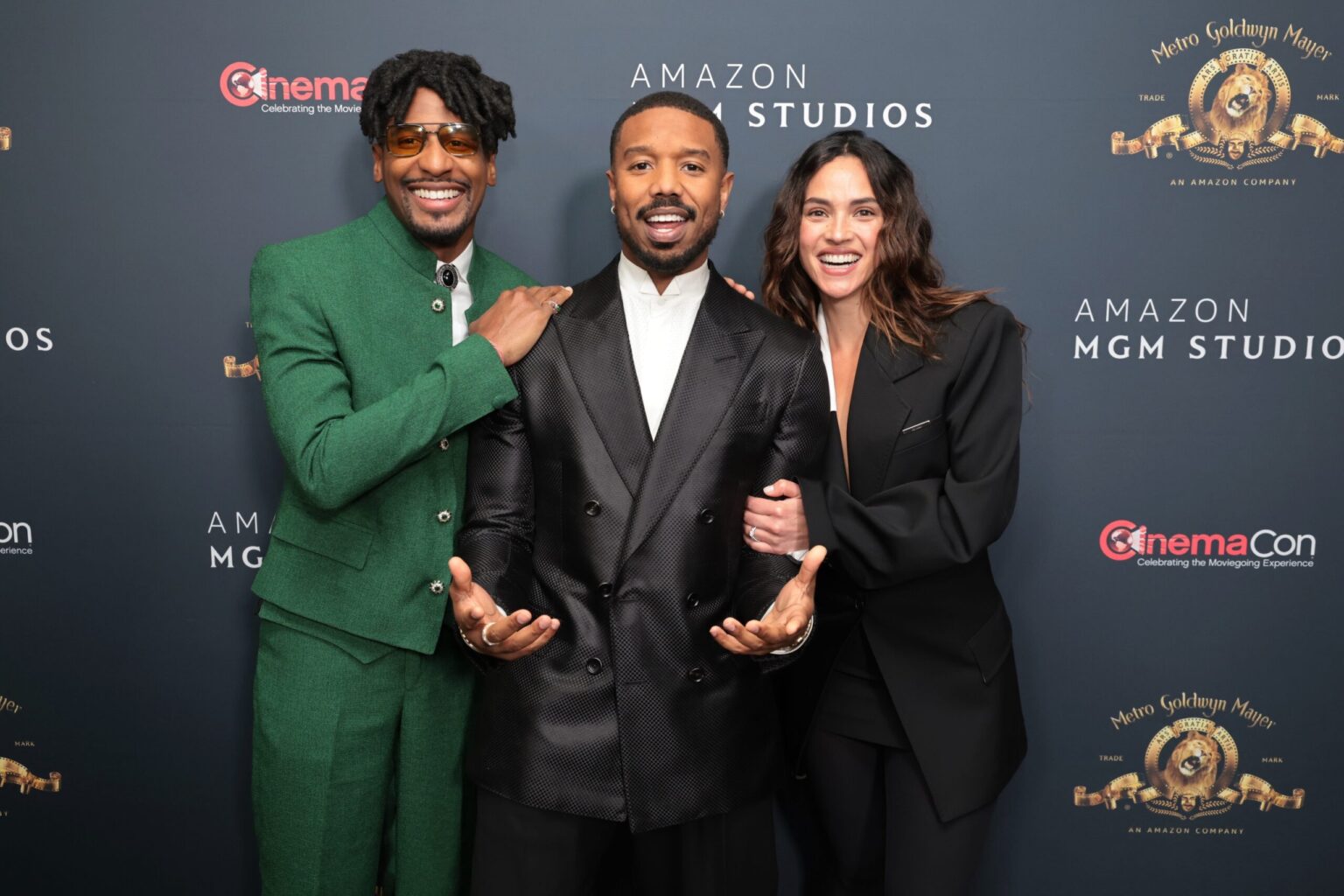 LAS VEGAS, NEVADA - APRIL 15: (L-R) Jon Batiste, Michael B. Jordan and Adria Arjona from "The Thomas Crown Affair" at the Amazon MGM Studios' CinemaCon 2026 Presentation at The Colosseum at Caesars Palace on April 15, 2026 in Las Vegas, Nevada. (Photo by Eric Charbonneau/Amazon MGM Studios via Getty Images)