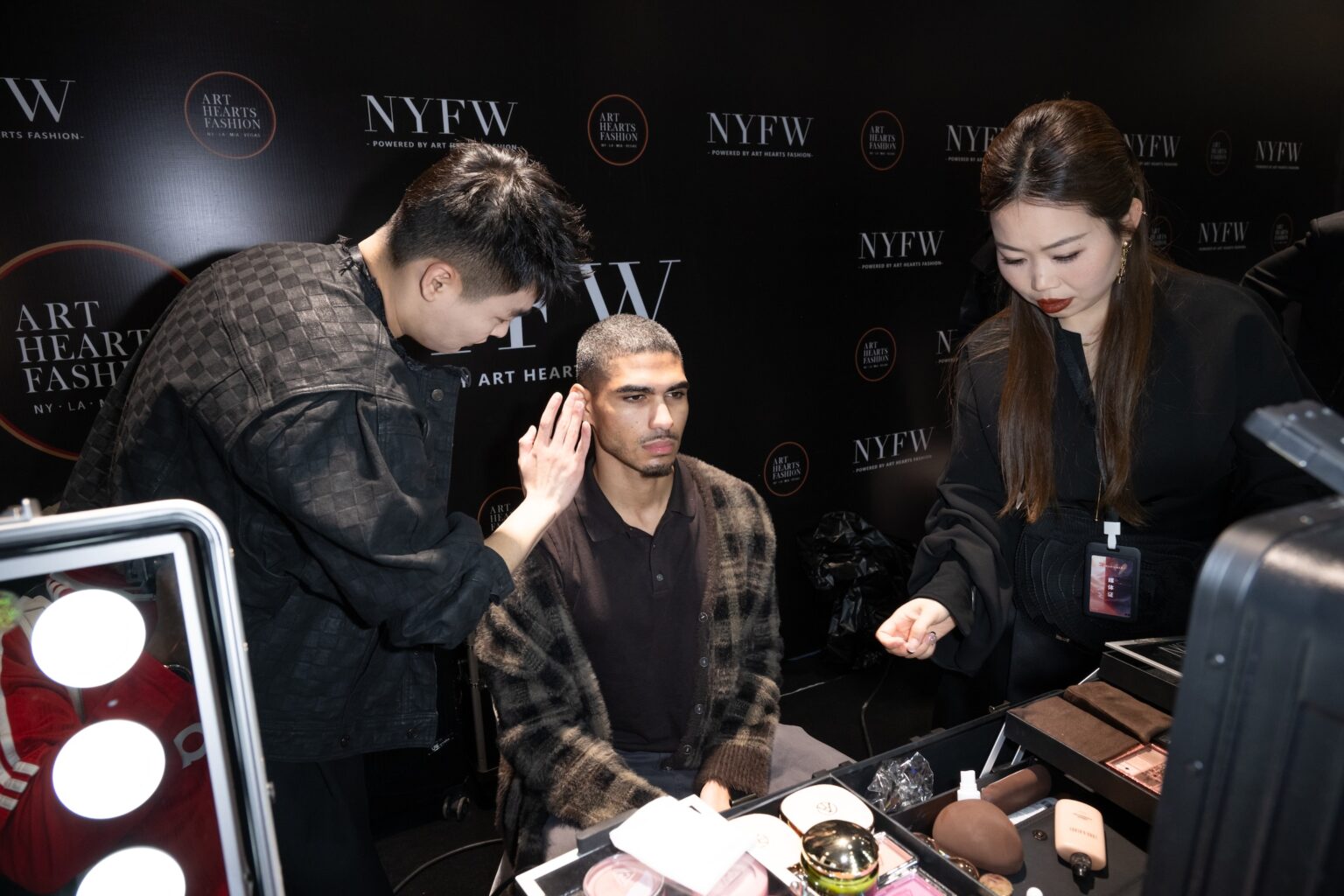 WUXI, CHINA - MARCH 19: A makeup artist applies makeup to a model backstage during Art Hearts Fashion Wuxi China at Smile Square Nianhua Bay on March 19, 2026 in Wuxi Jiangsu Province, China. (Photo by Mark Gunter/Getty Images for Art Hearts Fashion)