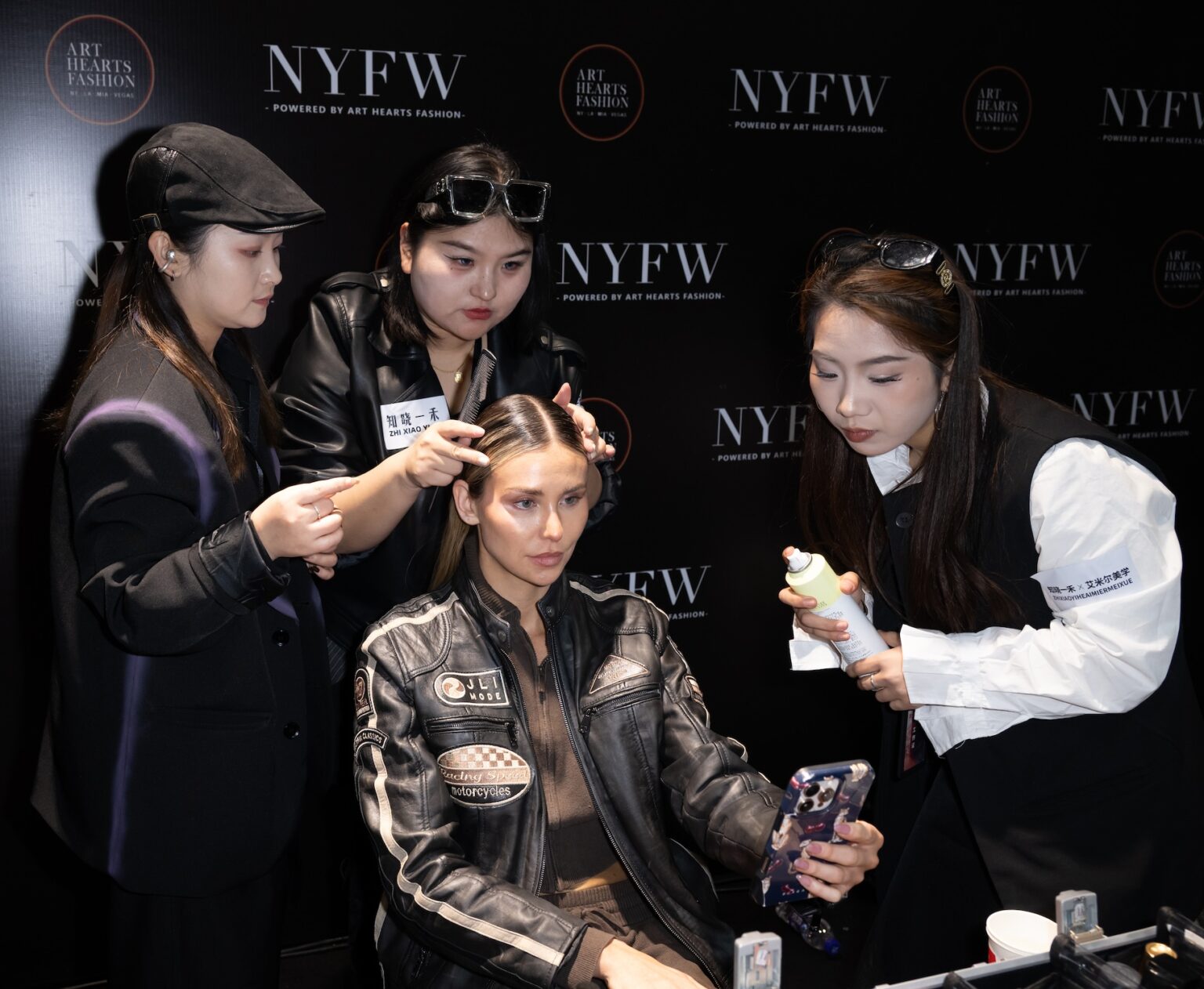 WUXI, CHINA - MARCH 19: Hairstylists prepare a model's hair backstage during Art Hearts Fashion Wuxi China at Smile Square Nianhua Bay on March 19, 2026 in Wuxi Jiangsu Province, China. (Photo by Mark Gunter/Getty Images for Art Hearts Fashion)