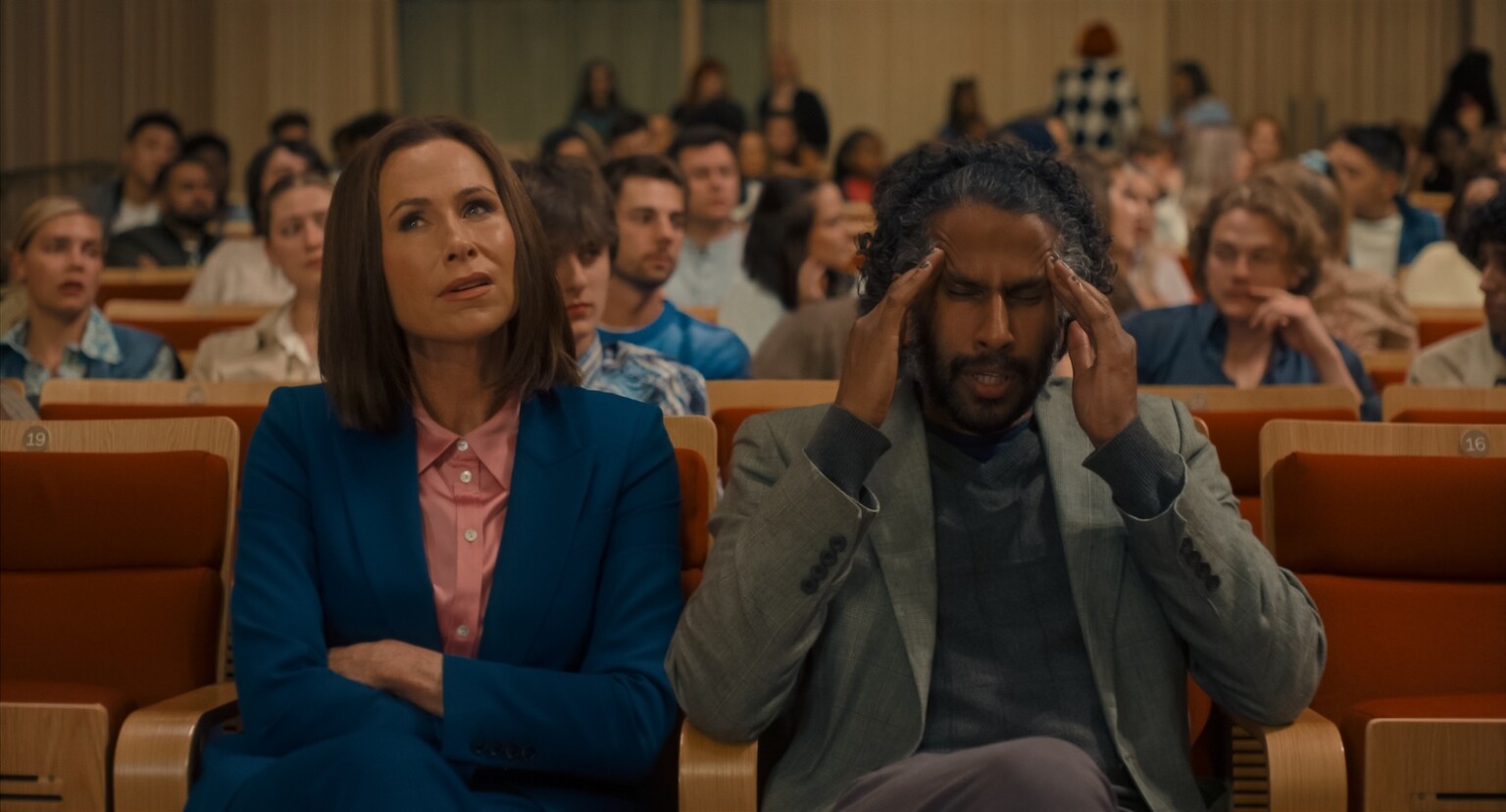 Minnie Driver stars as Dean Whittaker and Prasanna Puwanarajah as Professor Westlake in director Alicia MacDonald’s FINDING EMILY, a Focus Features release. Credit: Courtesy of Focus Features / © 2026 FOCUS FEATURES LLC