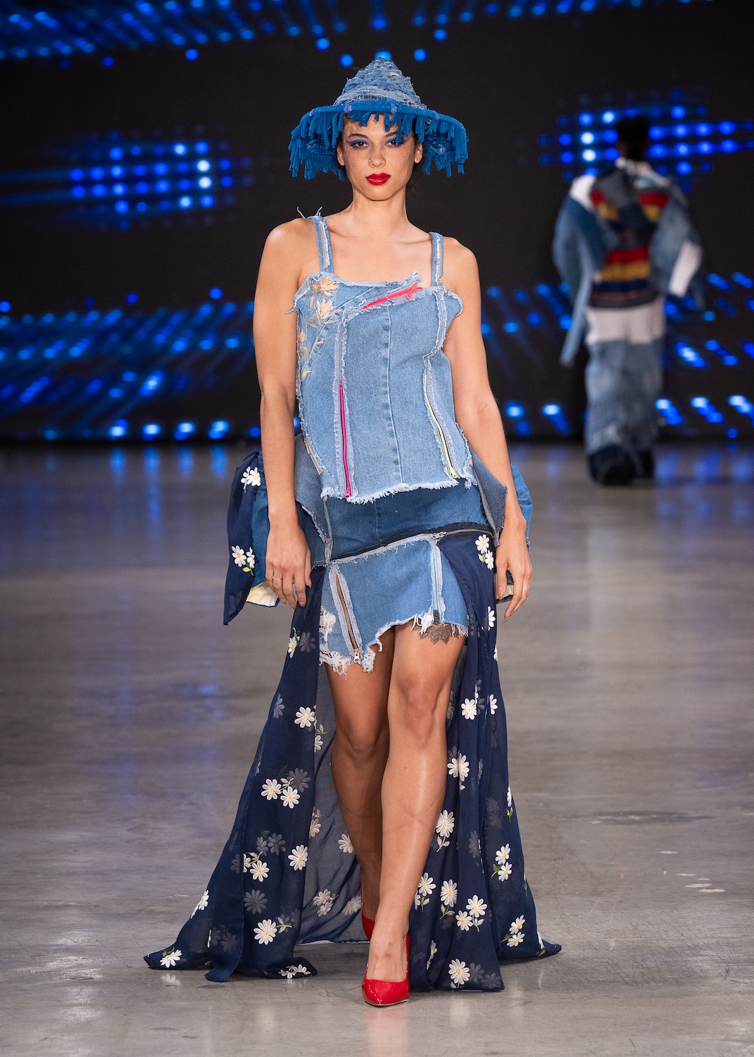 LOS ANGELES, CALIFORNIA - OCTOBER 18: A model walks the runway at the Upcycle Denim & Sustainability Project 2025 show during Los Angeles Fashion Week Powered By Art Hearts Fashion at The New Mart on October 18, 2025 in Los Angeles, California. (Photo by Mark Gunter/Getty Images for Art Hearts Fashion)