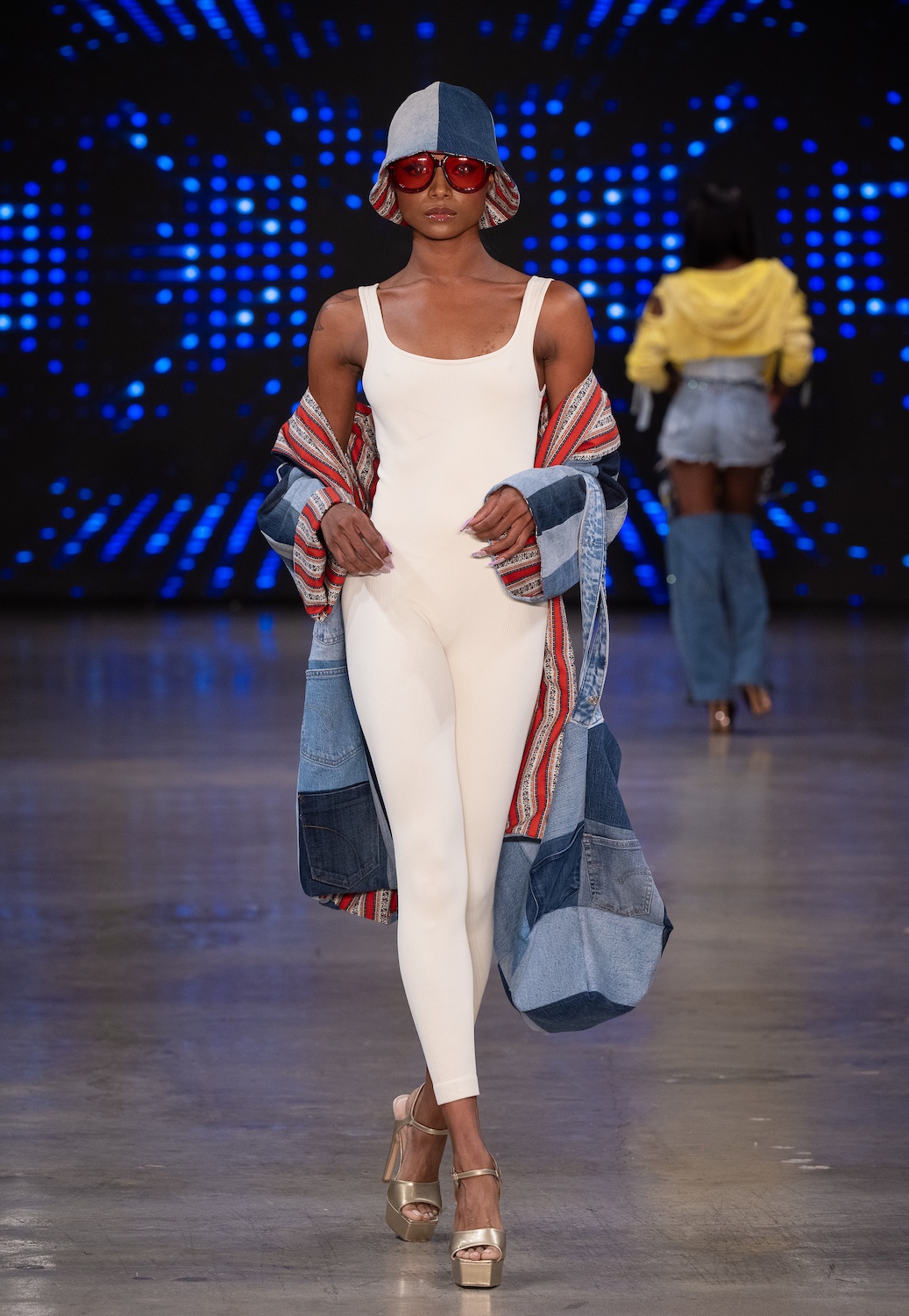 LOS ANGELES, CALIFORNIA - OCTOBER 18: A model walks the runway at the Upcycle Denim & Sustainability Project 2025 show during Los Angeles Fashion Week Powered By Art Hearts Fashion at The New Mart on October 18, 2025 in Los Angeles, California. (Photo by Mark Gunter/Getty Images for Art Hearts Fashion)